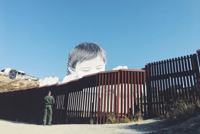 Photo of giant toddler peers over border into San Diego County
