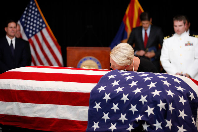Cindy McCain kisses husband's casket at service