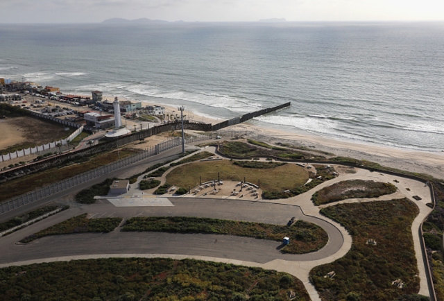 Aerial views of the U.S.-Mexico border fence at the beach