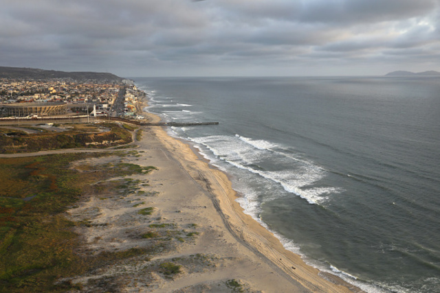 Aerial views of the U.S.-Mexico border fence at the beach