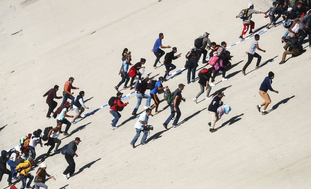 PHOTOS: Migrants rush US/Mexico border to demand asylum